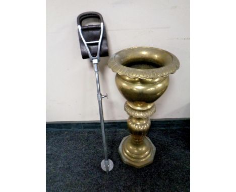 An ornate brass planter together with a shooting stick  