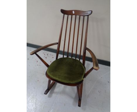 An Ercol solid elm and beech high back rocking chair in an antique finish 