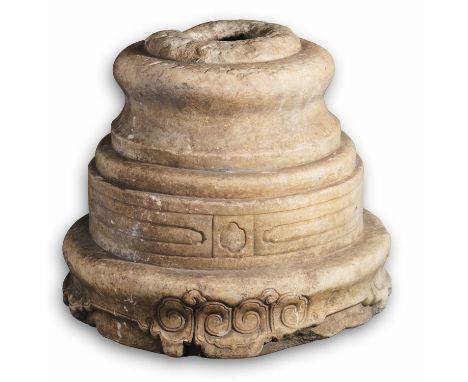 A CHINESE STONE FLAGPOLE HOLDER, LATE MING/EARLY QING DYNASTY of stepped cylindrical form, rising from a circular base carved
