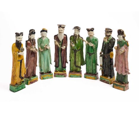 A RARE SET OF EIGHT CHINESE FAMILLE-VERTE DAOIST IMMORTALS, QING DYNASTY, KANGXI PERIOD (1662-1722) each standing on a rectan