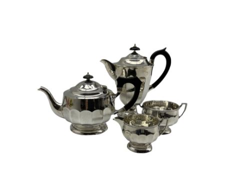 Silver three piece tea set of panel sided circular form, the teapot with ebonised handle and lift Sheffield 1927 Maker Cooper