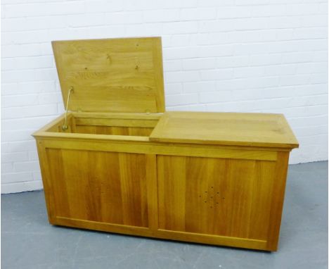 A contemporary storage trunk in light oak designed by Fired Earth, with twin hinged lids to the rectangular top, 60 x 125cm