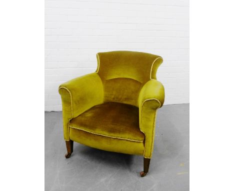 An upholstered armchair with curved back and shaped side supports on mahogany legs terminating in ceramic castors, 78 x 78cm 