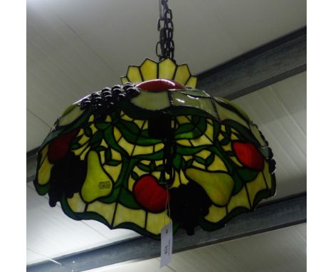 A Tiffany style glass lamp shade with fruit and foliage pattern 