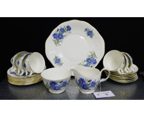 A Queen Anne china teaset, decorated with blue floral sprays with gilt rims, comprising six cups, six saucers, six side plate