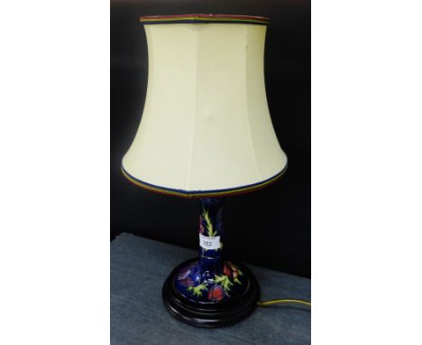 Moorcroft table lamp and shade, the cobalt blue ground tubeline decorated with flowers, on a turned wood base, 30cm high excl