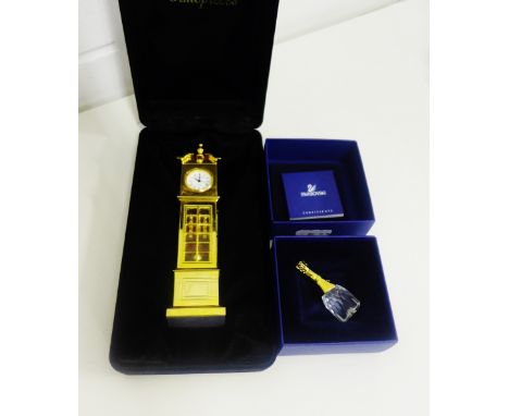 A Swarovski and gilt metal miniature champagne bottle together with a Classic Timepieces gilt metal longcase clock (2) 