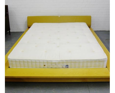 A contemporary double bed and mattress with a leather headboard and low beech frame surround, 240 x 190cm