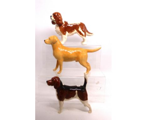 A group of three Beswick dog figures to include a Golden Retriever, Beagle and a King Charles Spaniel (3).