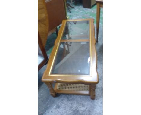 Yeh Brothers Oak coffee table with smoked glass inserts and rattan magazine shelf, H 41cm x W 133cm.