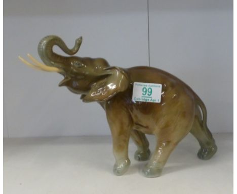 Royal Dux, model of an elephant with trunk in salute. Height: 20cm