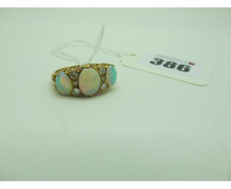 A Large Victorian Style 18ct Gold Opal and Diamond Set Ring, graduated oval cabochon set with brilliant cut diamond set highl