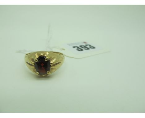 A 9ct Gold Garnet Single Stone Gent's Ring, oval claw set (finger size X) (4.7grams). 