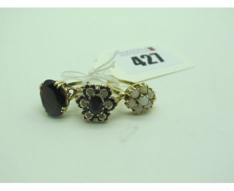 A 9ct Gold Cluster Ring, of flower head design, claw set throughout, between tapered shoulders (finger size N1/2), another si