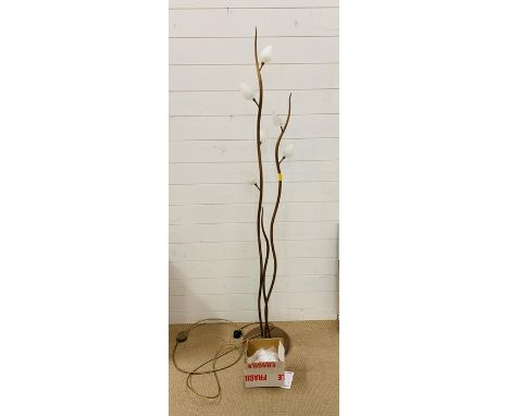 A floor standing metal light in the form of a plant 