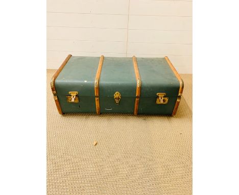 A green and wooden branded travel trunk  