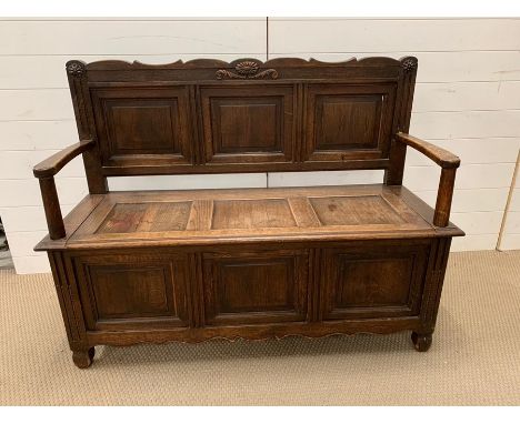 A carved monks bench (H98cm W128cm D48cm)