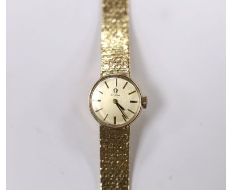 A lady's 9ct gold Omega manual wind wrist watch, on integral 9ct gold bracelet, overall length 15.5cm, gross weight 21.9 gram