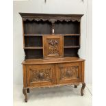 An early 20th century Flemish carved oak bow front dresser, width 138cm, depth 50cm, height