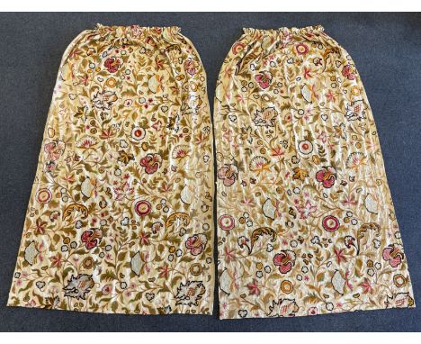 Two mid 20th century cream linen and ‘crewel work’ curtains, embroidered with chain stitch in multicoloured wools, both are u