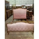 A Louis XV style upholstered gilt painted carved wood double bedstead, length 200cm, width 140cm,