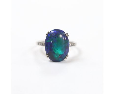 An 18ct, plat and single stone cabochon black opal set ring, with six stone diamond chip set shoulders, size K, gross weight 