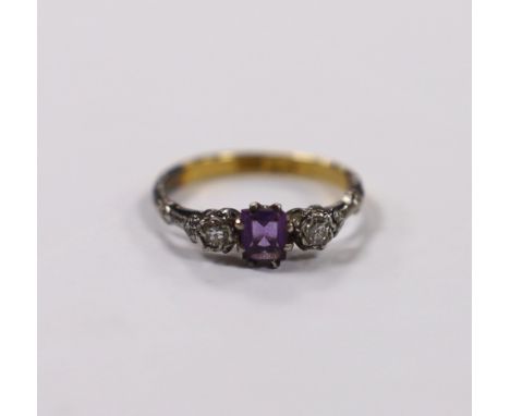An early 20th century 18ct and plat. single stone amethyst and two stone diamond set ring, size K, gross weight 2.1 grams.***