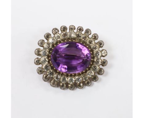 An early 20th century yellow and white metal, amethyst and paste set oval cluster brooch, 33mm.***CONDITION REPORT***PLEASE N