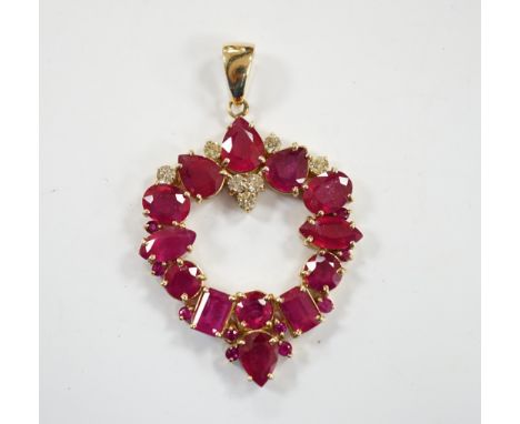 A modern 14k, ruby(treated) and diamond cluster set open work pendant, overall 52mm, gross weight 10.9 grams.***CONDITION REP