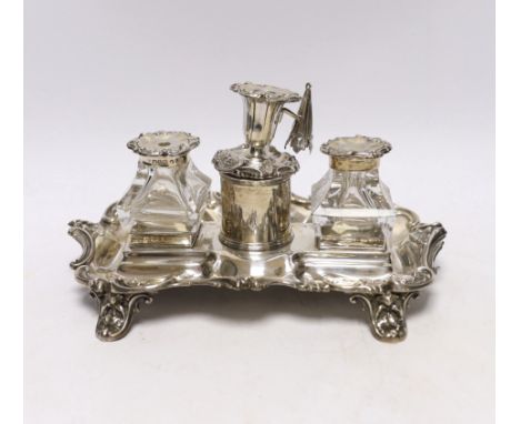 An early Victorian ornate silver inkstand, with two mounted glass wells and central taperstick, Henry Wilkinson &amp; Co, She
