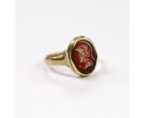An antique 9ct and intaglio glass? set oval ring, depicting the bust of a Roman soldier to dexter, size P, gross weight 3.8 g