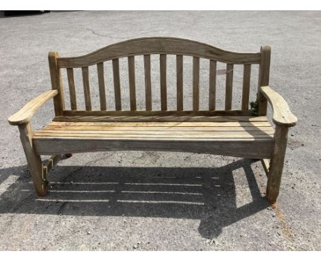 A weathered teak garden bench, width 161cm, height 90cm***CONDITION REPORT***PLEASE NOTE:- Prospective buyers are strongly ad