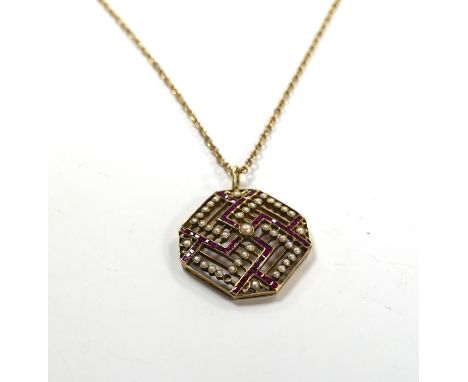 An Edwardian 15ct, ruby and seed pearl set octagonal pendant, 35mm, gross weight 9.7 grams, on a gilt metal chain.***CONDITIO