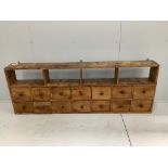 A Victorian pine bank of fourteen drawers, width 183cm, depth 21cm, height 66cm***CONDITION