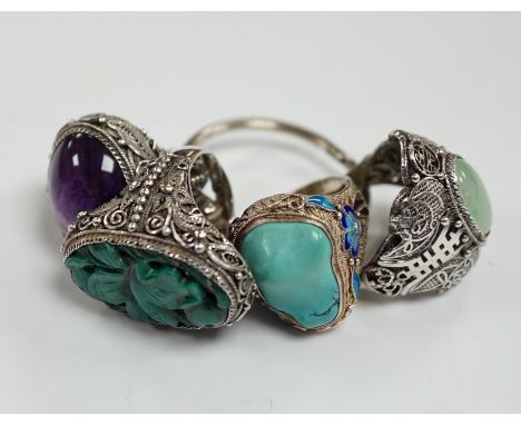 Four assorted Chinese white metal filigree and gem set rings, including turquoise and amethyst.***CONDITION REPORT***PLEASE N
