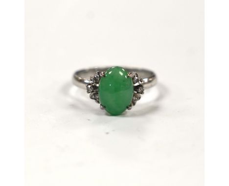 A modern 18k white metal and single stone cabochon jade and six stone diamond chip set ring, size O, gross weight 3 grams.***