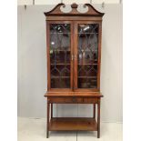 A George III and later two door mahogany bookcase on stand, width 98cm, depth 33cm, height 217cm***