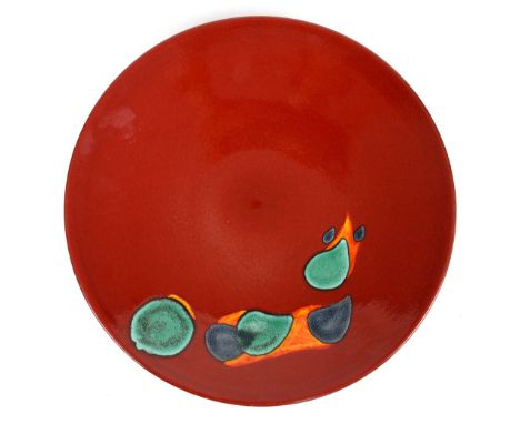Poole pottery charger/wall plaque, with turquoise blue and orange decoration on a deep red ground, printed marks verso, 41cm 