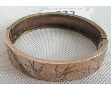 A late Victorian bangle, engraved in aesthetic taste with birds and foliage.