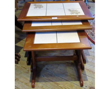 A nest of three mid-20th century teak coffee tables with tile insets.