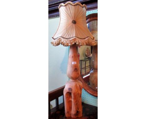A carved wooden table lamp.