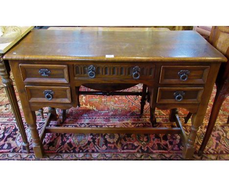 A mid-20th century ercol-style oak five drawer desk.