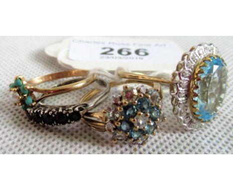 A turquoise and seed pearl cluster ring and three further rings.