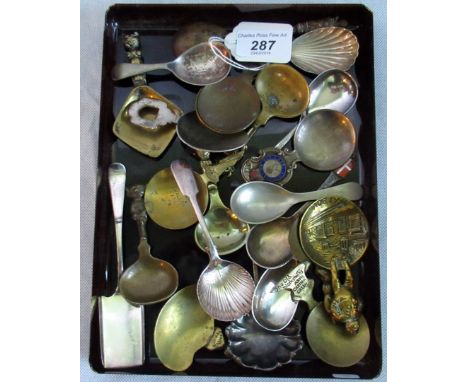 A collection of brass and silver plated caddy spoons.