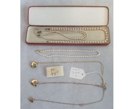 A heart-shaped locket and chain marked '9ct', together with two further hear-shaped locket pendants and chains, a baroque pea