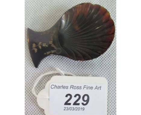 A silver inlaid tortoiseshell caddy spoon.