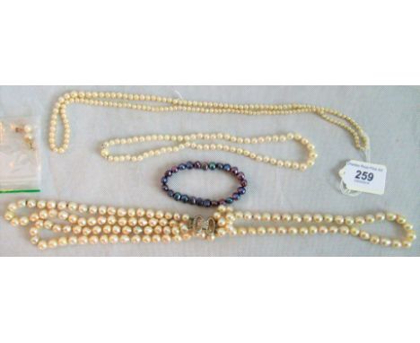 A three row baroque pearl necklace to a diamond set double loop clasp, together with a single row of graduated cultured pearl