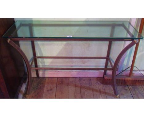 A contemporary metal and glass topped console table, bearing the label Pierre Vandel, Paris.