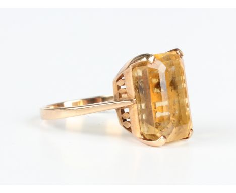 A gold ring, claw set with a cut cornered rectangular step cut citrine, detailed 'JM 14ct', weight 5.6g, ring size approx M.B