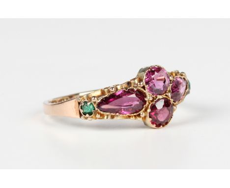 A 12ct gold, garnet and green gem set ring, mounted with two circular cut garnets between two pear shaped garnets, otherwise 